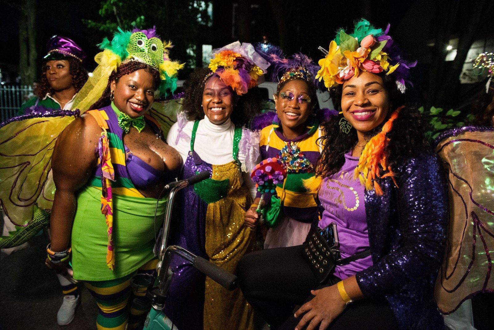 Parade participants wearing green and gold costumes and flower crowns