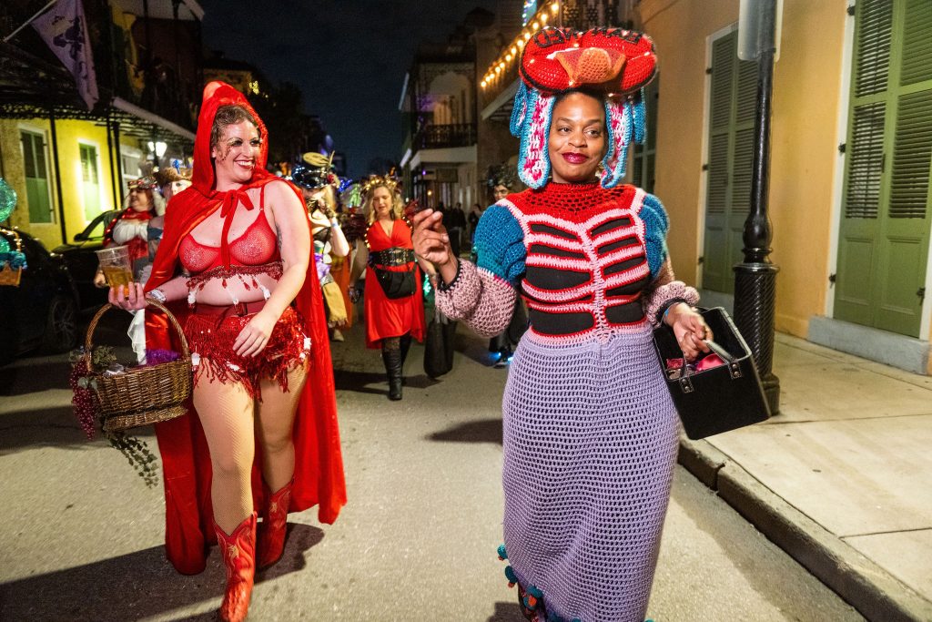 Members of the Krewe of Goddesses sashay down the street dressed as female reproductive systems.